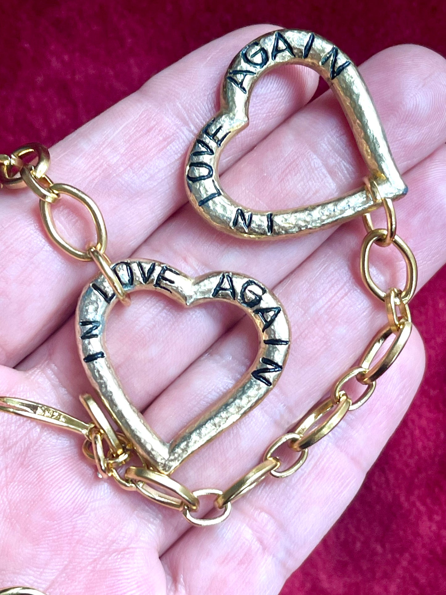 Front view closeup Vintage YSL heart pendants, minor signs of age visible