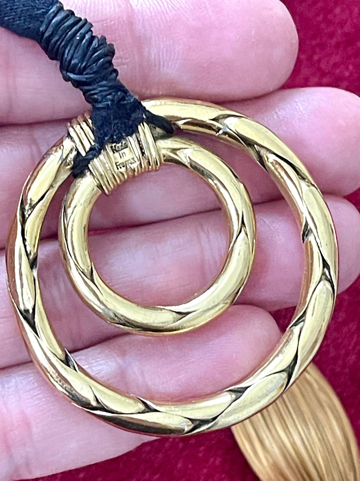 Close-up of vintage Yves Saint Laurent YSL gold tone scarf holder signed Made in France