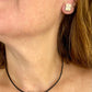 YSL vintage silver earrings and matching pendant necklace set placed together worn by model 
