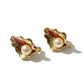 Vintage Yves Saint Laurent gold-tone calla lily earrings with pearl centers, sculptural floral design On a white background 