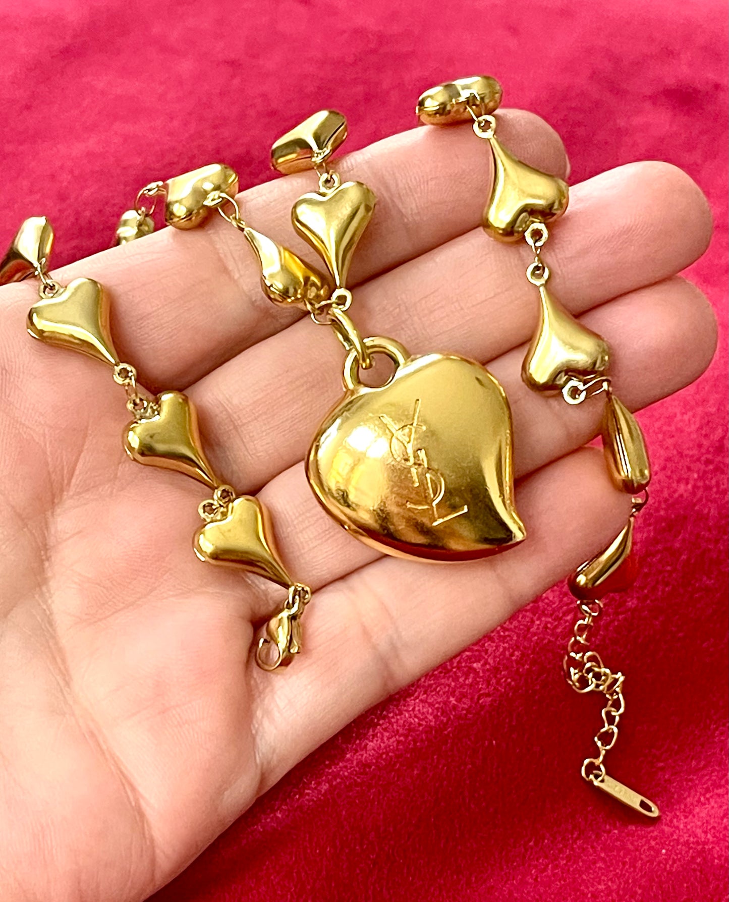 Back view Vintage YSL rhinestone heart pendant necklace held in hand showing size and gold chain detail, Valentine's Day gift