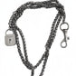 Vintage Saint Laurent upcycled necklace featuring a dark gunmetal chain with original lock and key charm pendant, repurposed from a Saint Laurent keychain, photographed on a white background