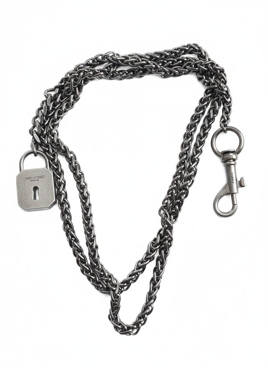 Vintage Saint Laurent upcycled necklace featuring a dark gunmetal chain with original lock and key charm pendant, repurposed from a Saint Laurent keychain, photographed on a white background
