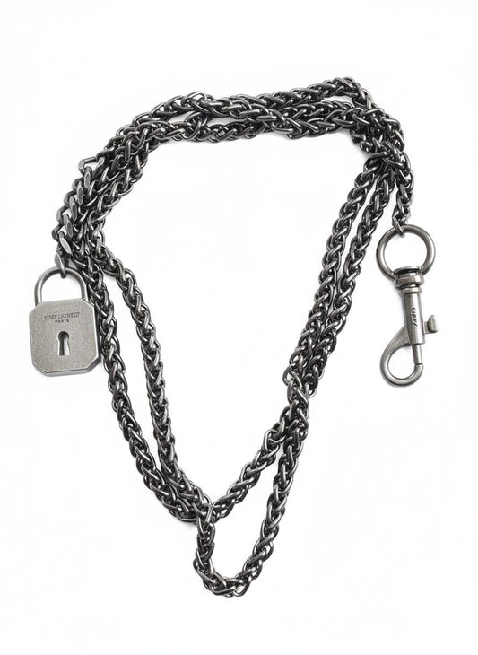 Vintage Saint Laurent upcycled necklace featuring a dark gunmetal chain with original lock and key charm pendant, repurposed from a Saint Laurent keychain, photographed on a white background