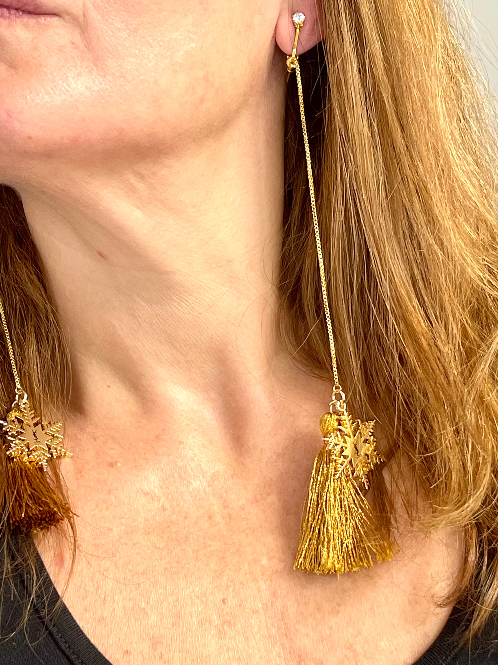 Side viewYves Saint Laurent signed snowflake charm tassel earrings in gold tone,
