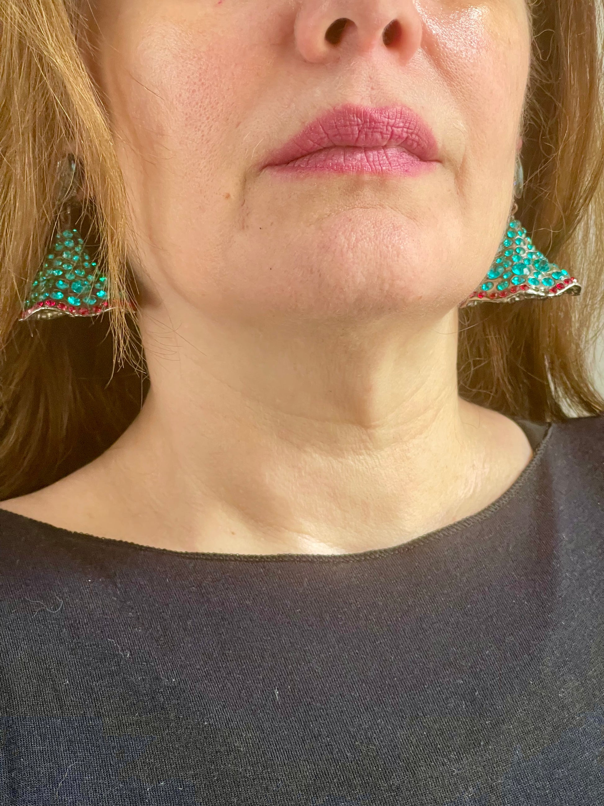 Worn by model a pair of collectors clip on vintage Yves Saint Laurent Rive Gauche vintage statement earrings with turquoise and red rhinestones 