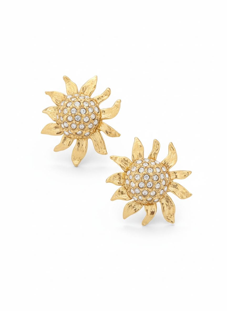 Vintage Yves Saint Laurent Gold sun-shaped earrings with rhinestones on a white background