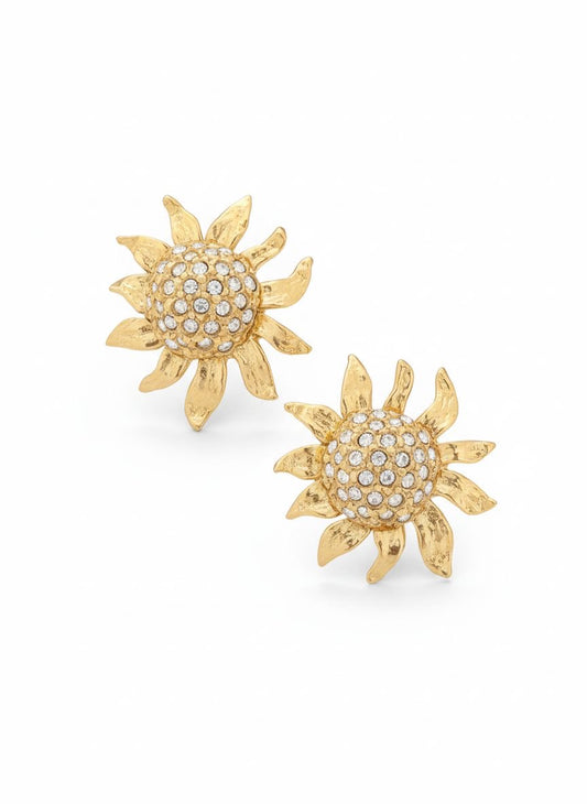 Vintage Yves Saint Laurent Gold sun-shaped earrings with rhinestones on a white background