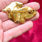 Back view signed YSL made in France Vintage Yves Saint Laurent 80s 90s gold tone leaf brooch excellent condition on white and red background 