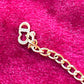 Close-up of Christian Dior CD logo charm on vintage 18K gold-plated necklace