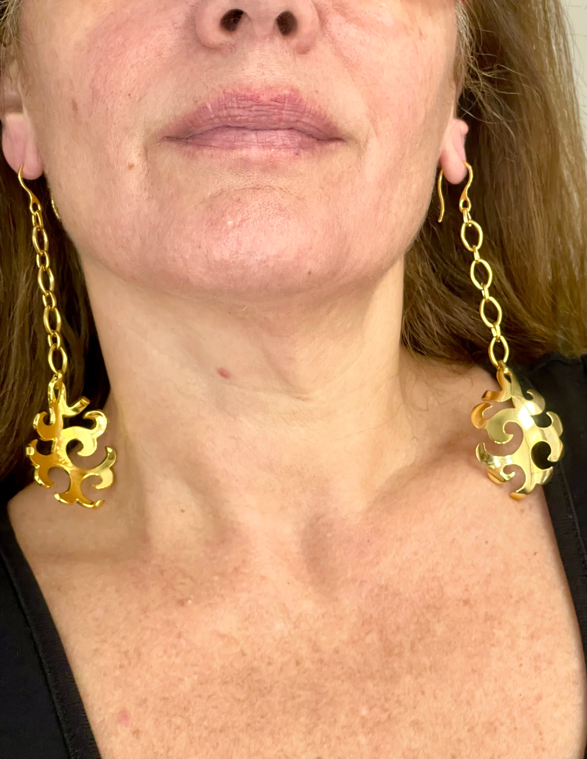 Vintage YSL long earrings worn by model for scale and styling reference