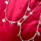 Upcycled Dior Beauté phone charm necklaces with removable silver-tone charms close up 
