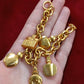 Detail of gold-tone chain and charms on Dior bracelet, very good vintage condition displayed on hand 
