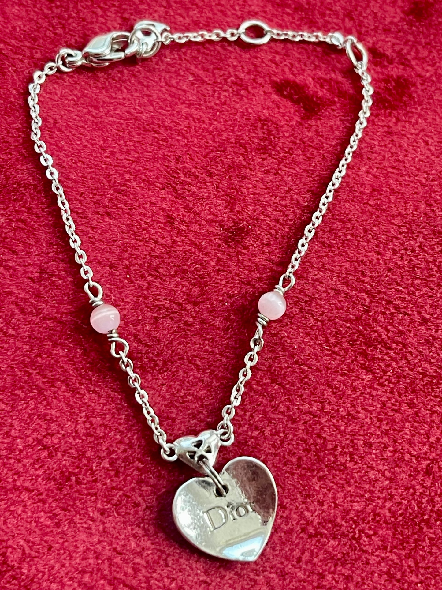 Vintage Dior silver tone rose beads chain bracelet with D charm signed on a red velvet background 