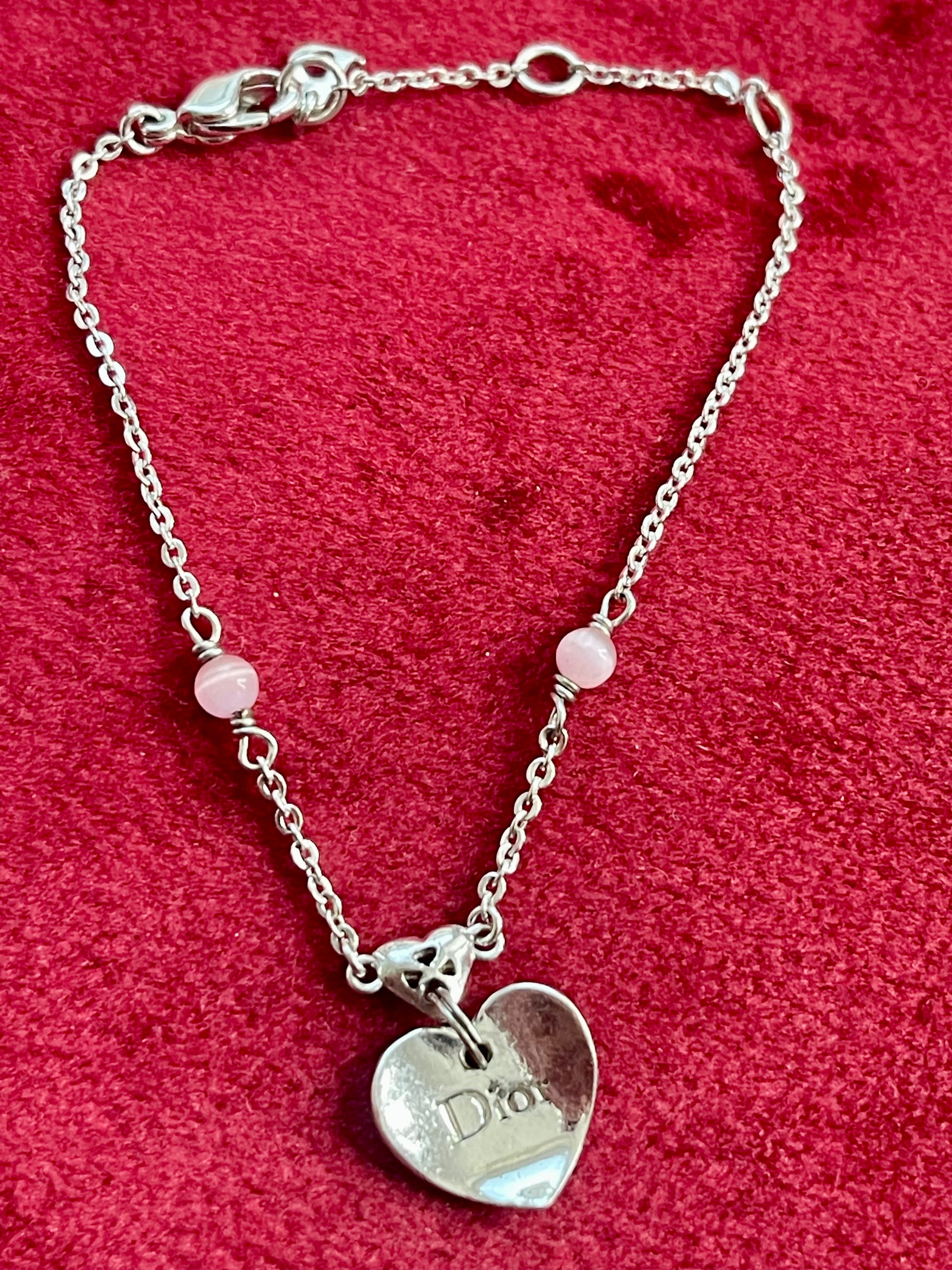 Vintage Dior silver tone rose beads chain bracelet with D charm signed on a red velvet background 