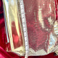 Showing width size view of Paco Rabanne silver shoulder/wrist bag with both straps shown, on red velvet fabric background using a measuring tape 