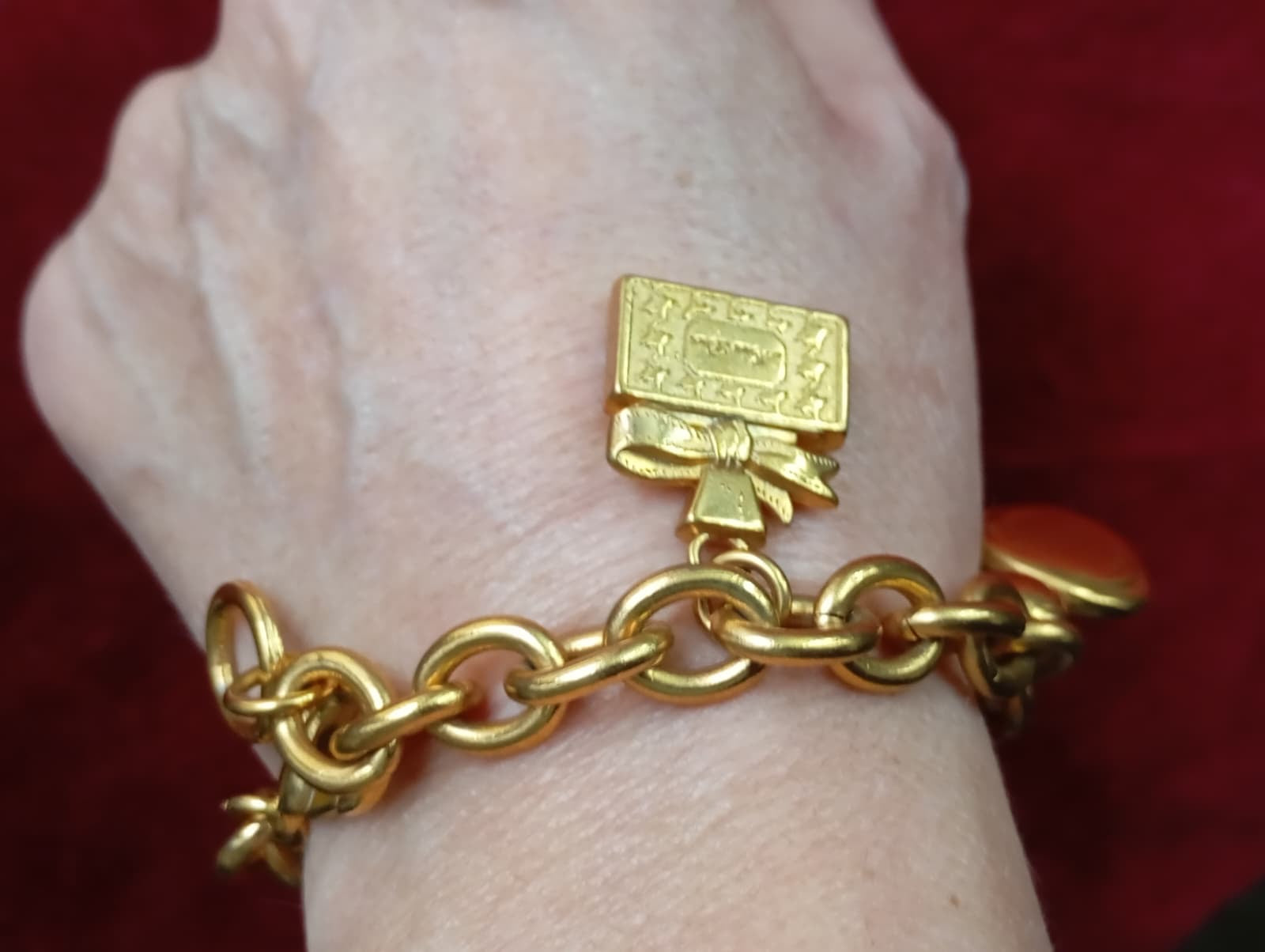 Close-up of Dior perfume bottle charms referencing Miss Dior worn on wrist