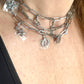 Choker style up close on upcycled Dior Beauté phone charm necklace with removable silver-tone charms