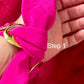 Close-up of a hand wearing a bright  Dior pink scarf bracelet set  with a gold accent , labeled 'Step 1'.