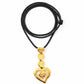 yves saint laurent heart pendant on black string on white background