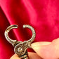 Buckle view close up Preloved YSL bronze and grey chain on a red red velvet vintage Yves Saint Laurent 