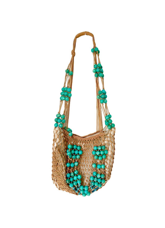 Full view of Paco Rabanne macramé shoulder bag with turquoise beads and zipper closure, hanging on a white background limited edition 