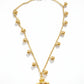 Gold necklace with a yellow pendant on a white background
