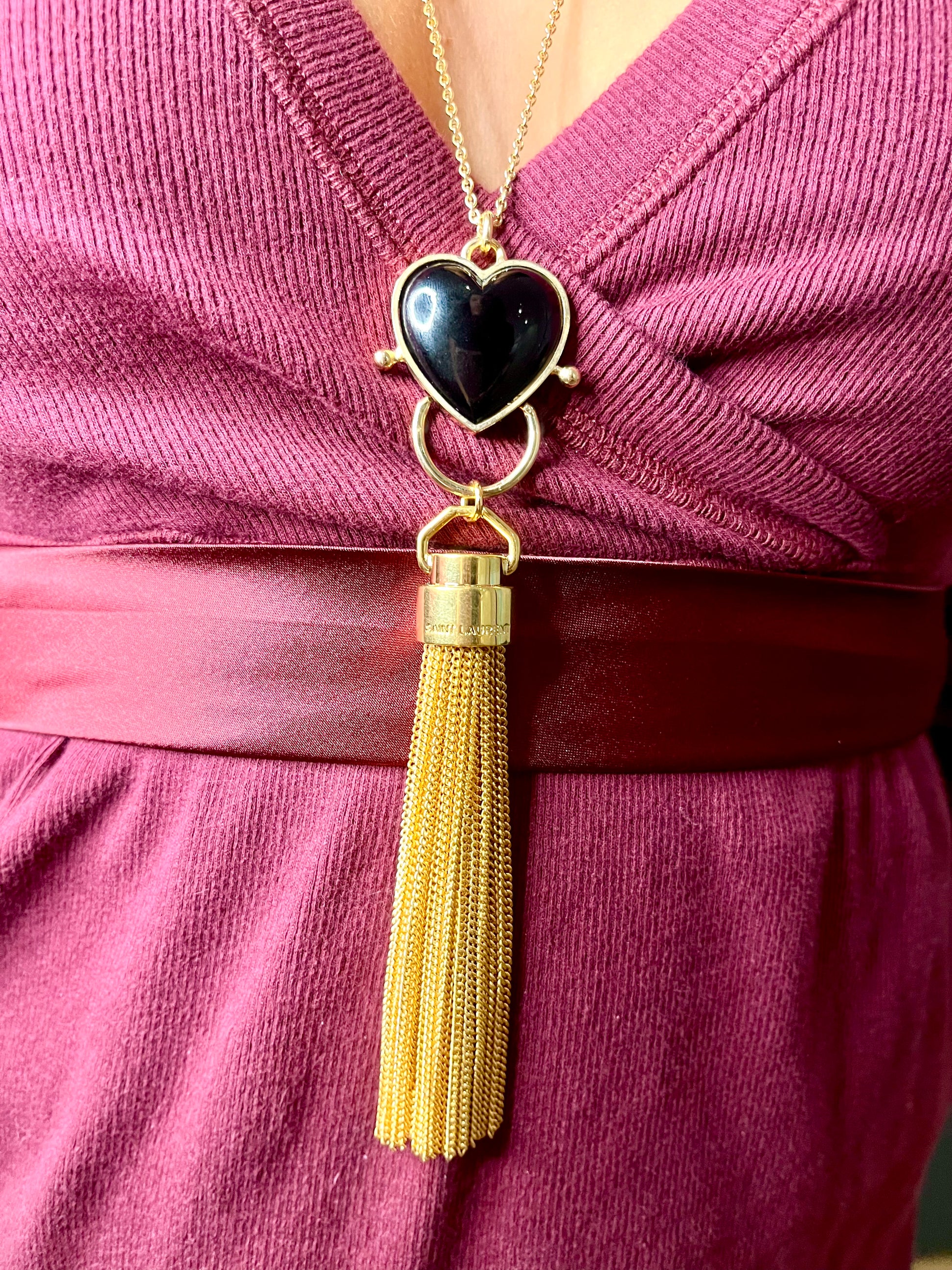 Close up on  Gold-plated necklace from Mutton Collet with Saint Laurent tassel charm 