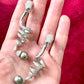 Side by side on hand showing Grossé earrings Dior elegant drop design and pearl detail