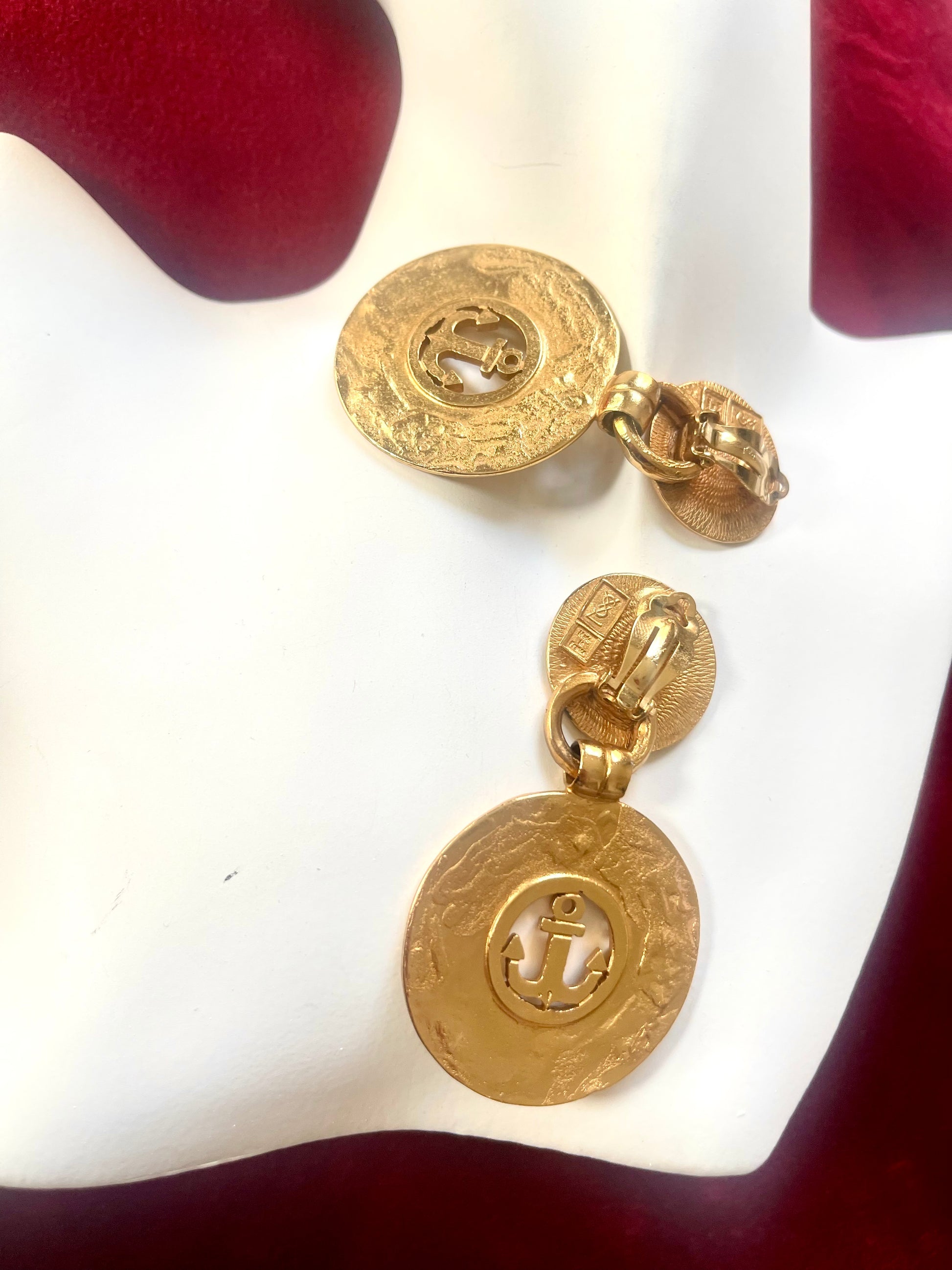 Side view of back side vintage YSL anchor statement earrings showing textured finish and clip-on backs.