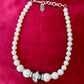 Yves Saint Laurent Vintage classic Faux Pearl Necklace grey white on a red velvet background 