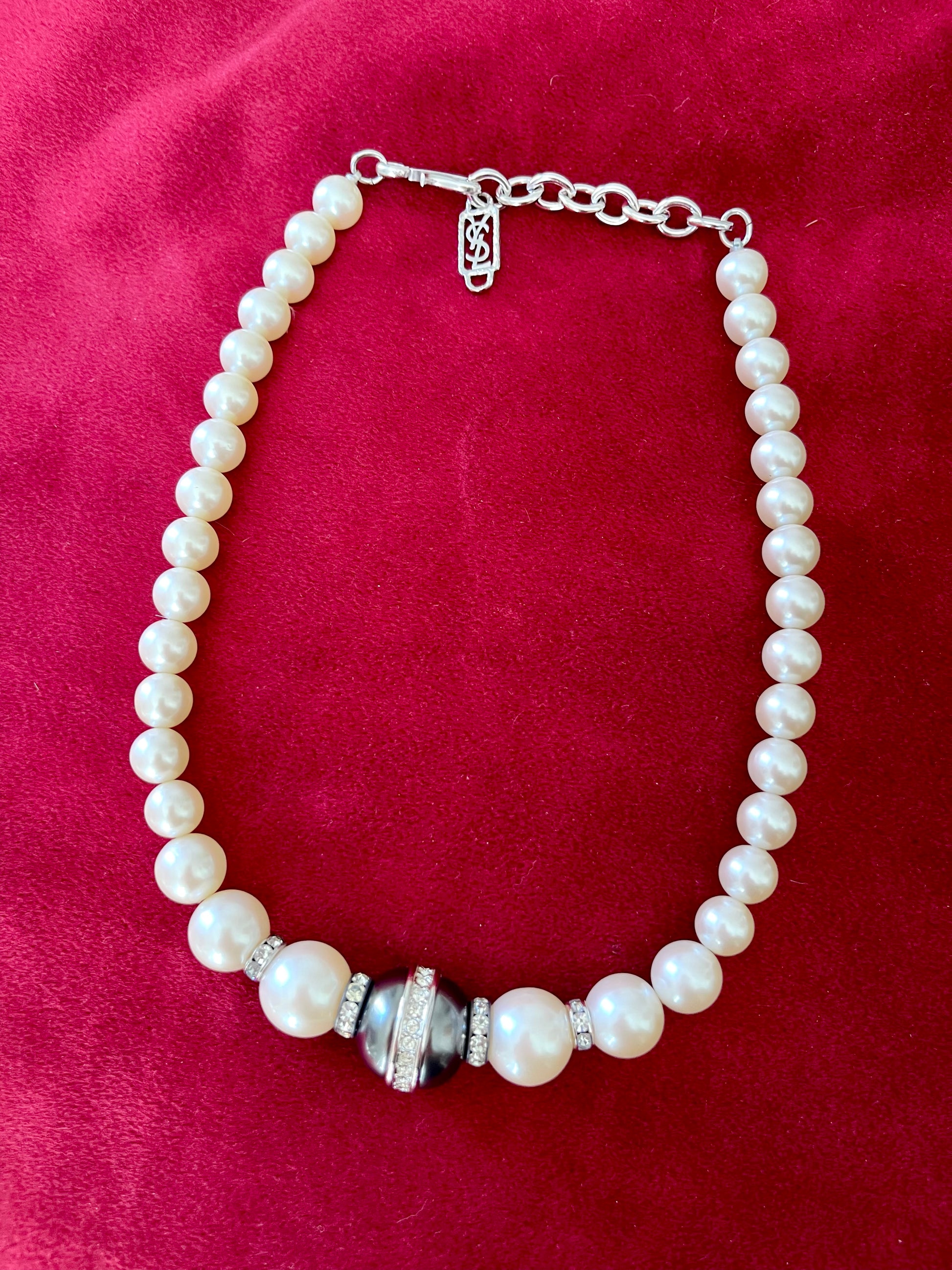 Yves Saint Laurent Vintage classic Faux Pearl Necklace grey white on a red velvet background 