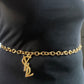 Large Yves Saint Laurent YSL logo pendant from vintage bag charm, styled as long necklace or belt.
