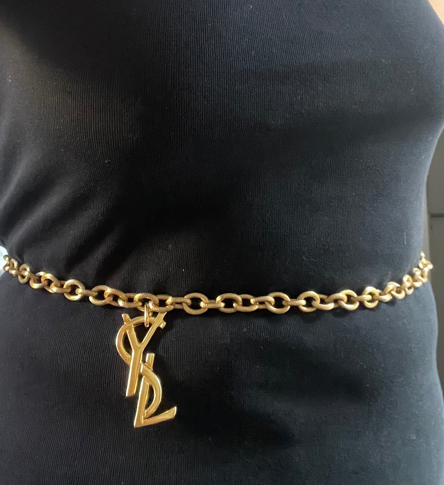 Large Yves Saint Laurent YSL logo pendant from vintage bag charm, styled as long necklace or belt.