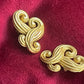 Pair of vintage Nina Ricci statement heart earrings with artistic swirling form