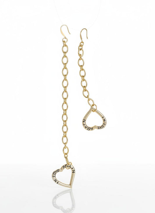 Yves Saint Laurent upcycled heart pendant earrings, front view on white background