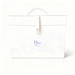 White Dior perfume bag with purple logo on a white background