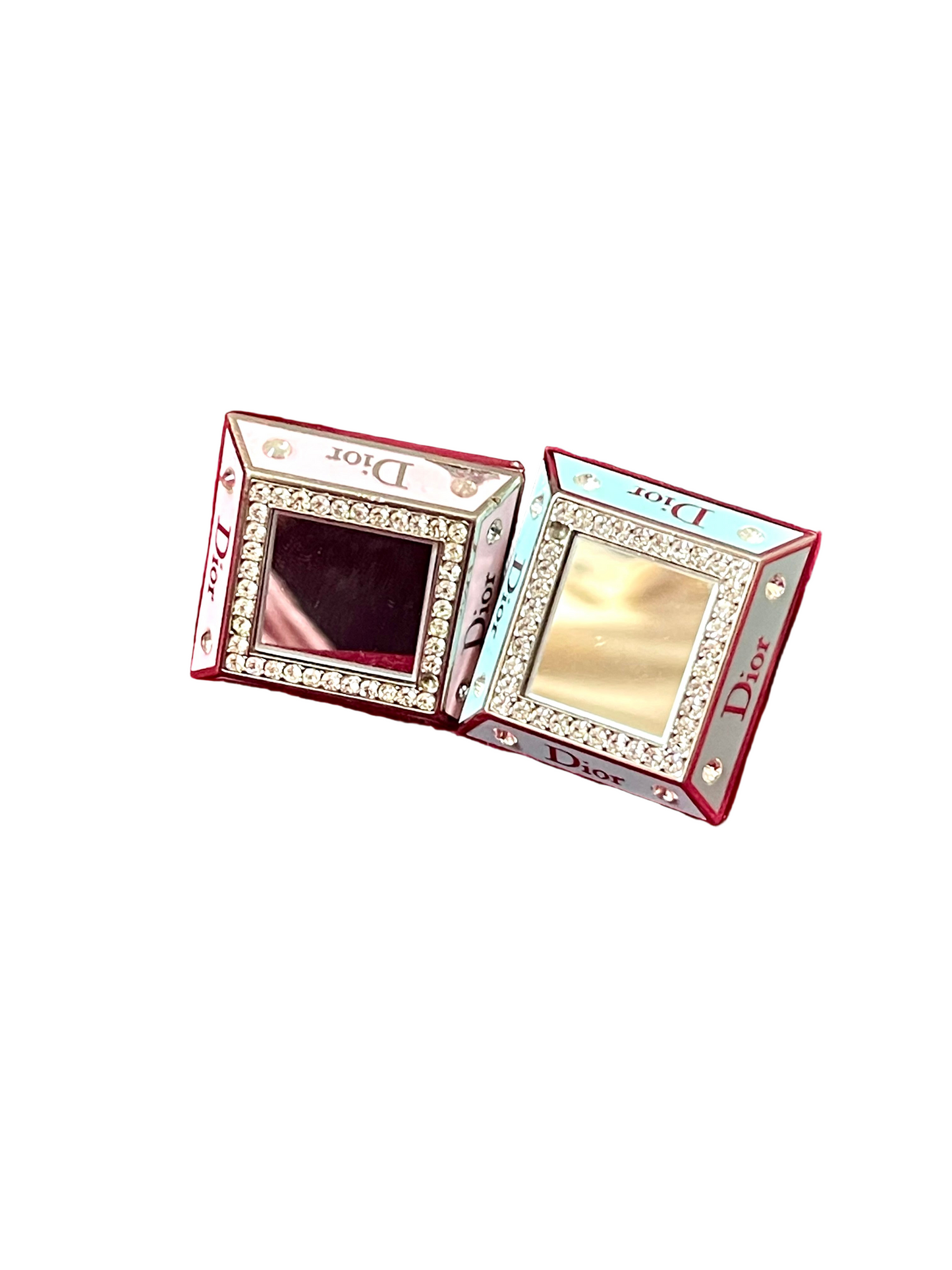Two Dior makeup mirrors rings with decorative frames on a white background