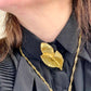 Close up worn by model Vintage Yves Saint Laurent 80s 90s gold tone leaf brooch excellent condition designer jewelry 
