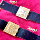 Side view Fashion Bracelet makeup Yves Saint Laurent vintage 2000 displayed with YSL pins on a red velvet background 