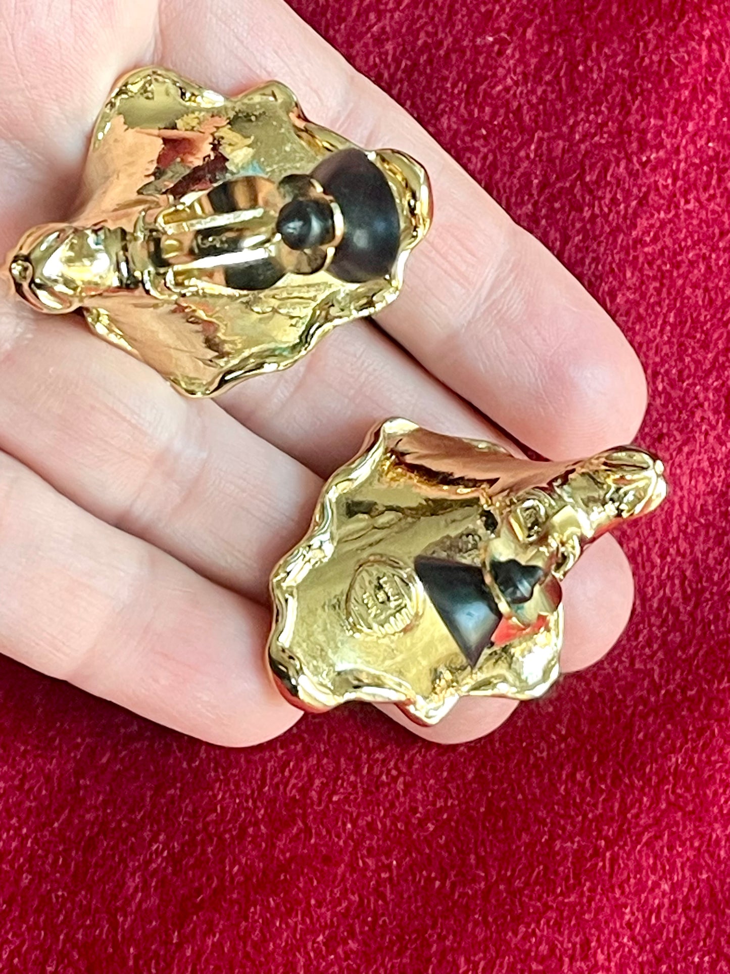 Backside view held by hand Vintage YSL statement earrings featuring gold-tone floral calla lily shape and luminous pearls showing signature made in France and hallmark YSL