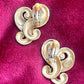 Backside view of Vintage Nina Ricci swirly heart earrings in matte gold plated metal, signed Nina Ricci Paris, 1990s design