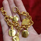 Close up view Detail of gold-tone chain and charms on Dior bracelet, very good vintage condition displayed on hand 