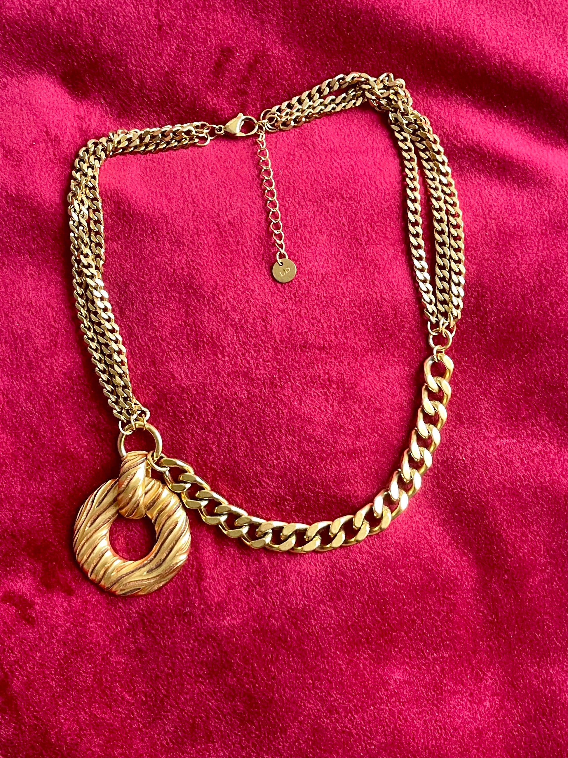 Yves Saint Laurent vintage pendant  stainless steel chain necklace Alternative style on red background 