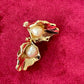 Vintage YSL statement earrings featuring gold-tone floral calla lily shape and luminous pearls