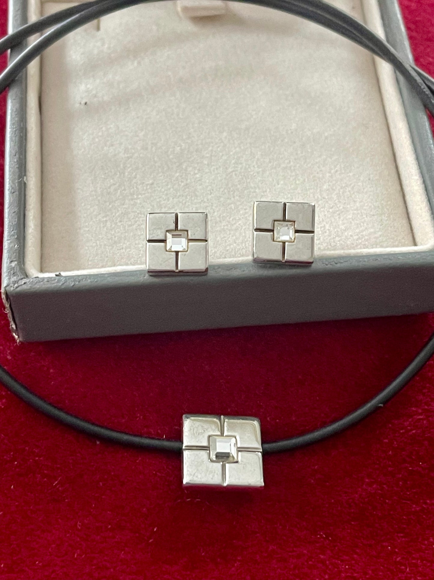 Vintage Yves Saint Laurent silver 925 earrings and pendant necklace set displayed on a red velvet background With their package 