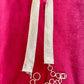 Flat lay vintage silver Paco Rabanne mesh belt on red velvet background.