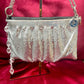 Front view of the One of a kind handmade Paco Rabanne repurposed silver pixel mesh bag on a red background 