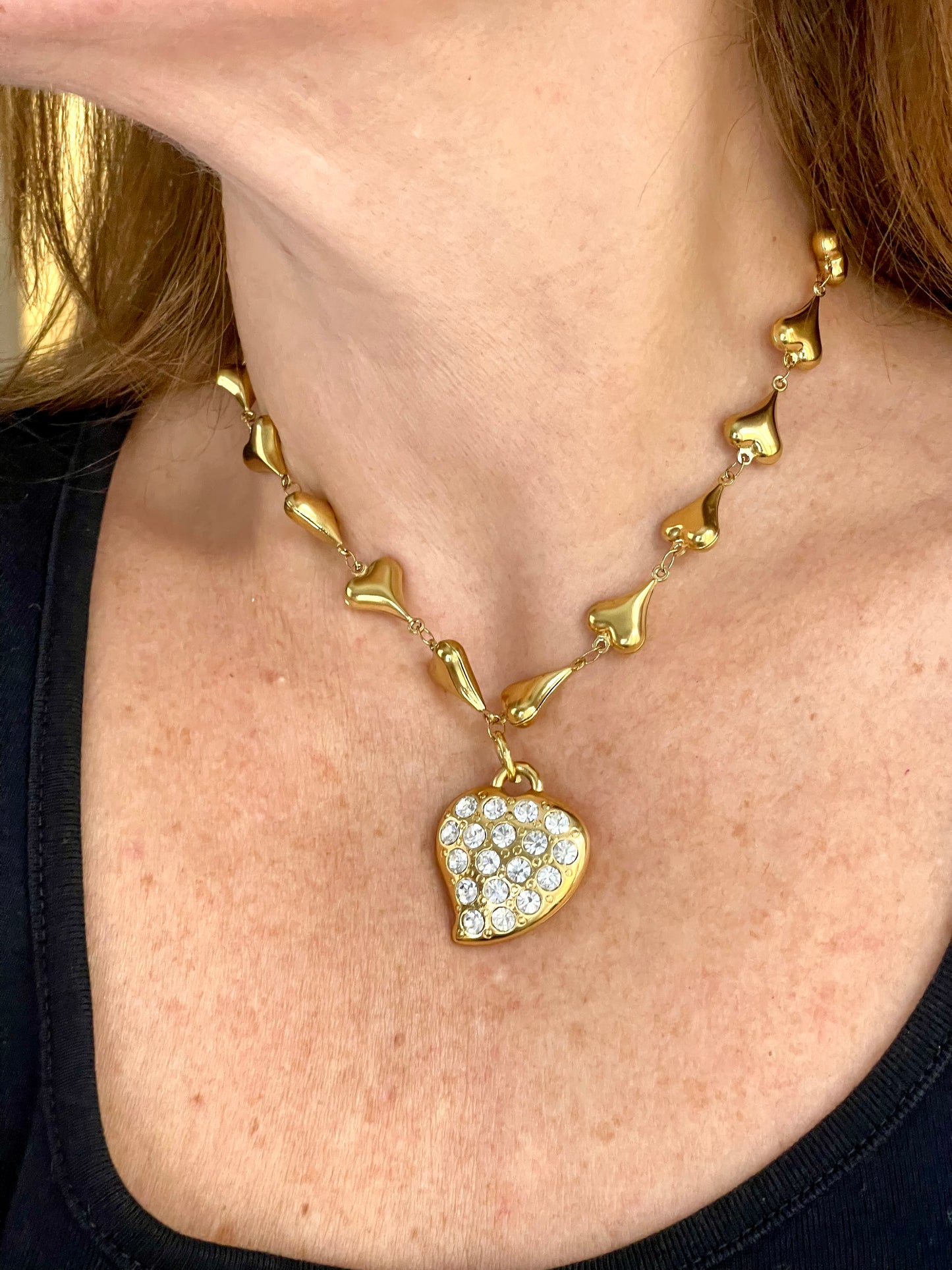 Worn by model Vintage YSL rhinestone heart pendant necklace held in hand showing size and gold chain detail, Valentine's Day gift