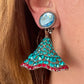 Close-up of Yves Saint Laurent Rive Gauche vintage statement earrings with turquoise and red rhinestones worn by model right side 